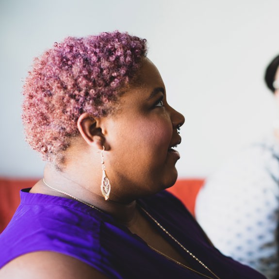 Woman with purple hair smiling