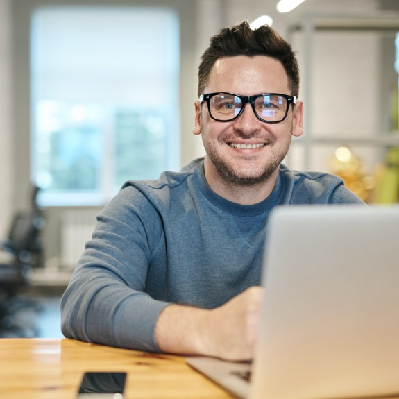 Man with computer smiling