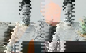 Woman smiling to her laptop