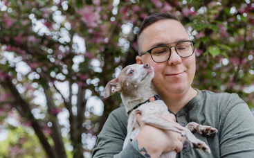 Man holding a small dog