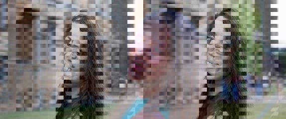 Woman smiling in front of university