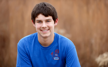Teenager with blue t-shirt smiling